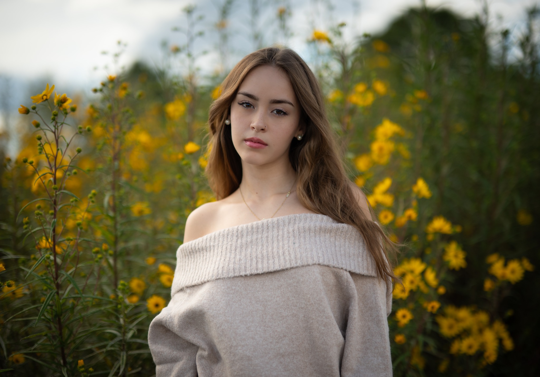 Natural-light portrait of a woman among yellow wildflowers