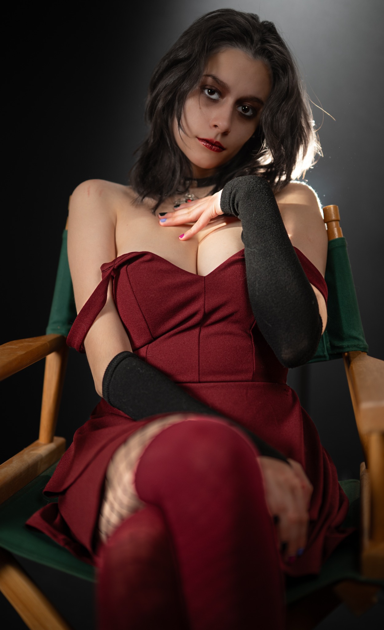 Dramatic studio portrait of a woman in a deep-red dress