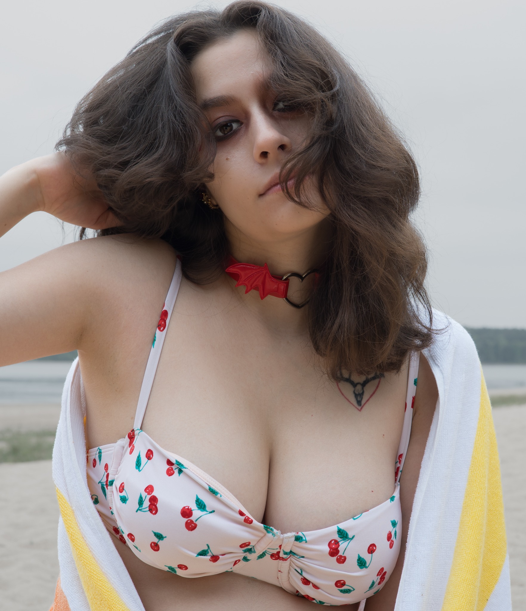 Close lakeside portrait in a cherry-print swimsuit