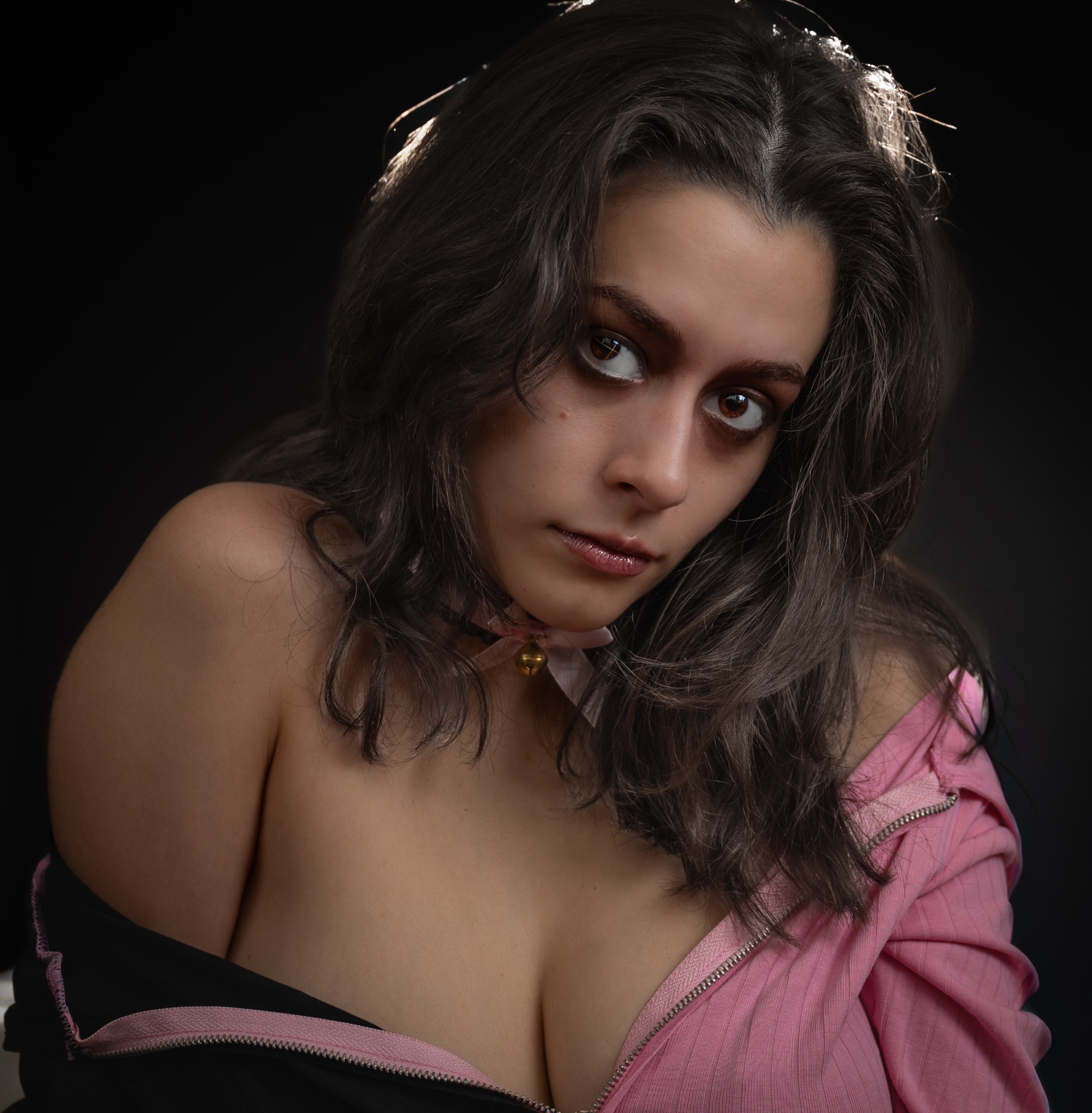 Close studio portrait of a woman in a pink jacket